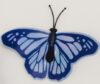 Creative illustration of butterflies representing thoughts over a brain silhouette.
