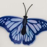 Creative illustration of butterflies representing thoughts over a brain silhouette.